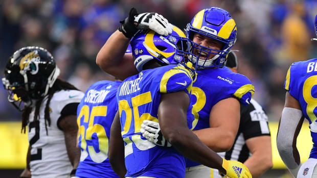 Dec 5, 2021; Inglewood, California, USA; Los Angeles Rams running back Sony Michel (25) celebrates with guard Austin Corbett (63) his touchdown scored against the Jacksonville Jaguars during the first half at SoFi Stadium. Mandatory Credit: Gary A. Vasquez-USA TODAY Sports